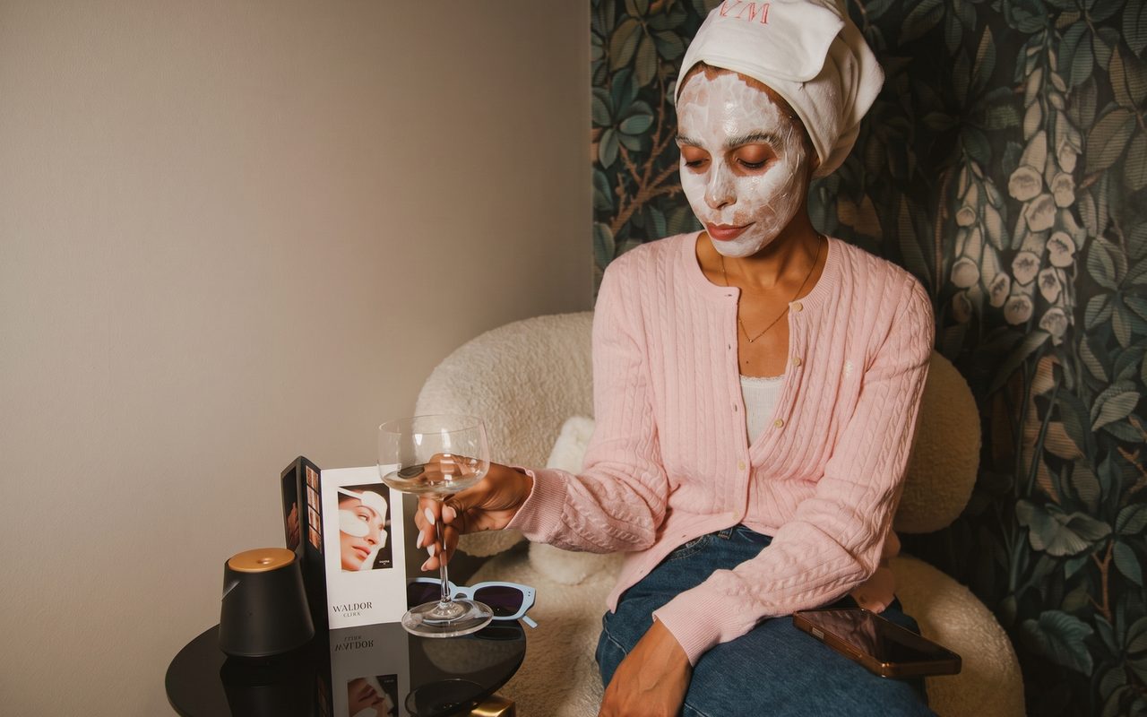 A client relaxing in a robe with a HydraGlass face mask at Waldor Clinic, Great Portland Street, London
